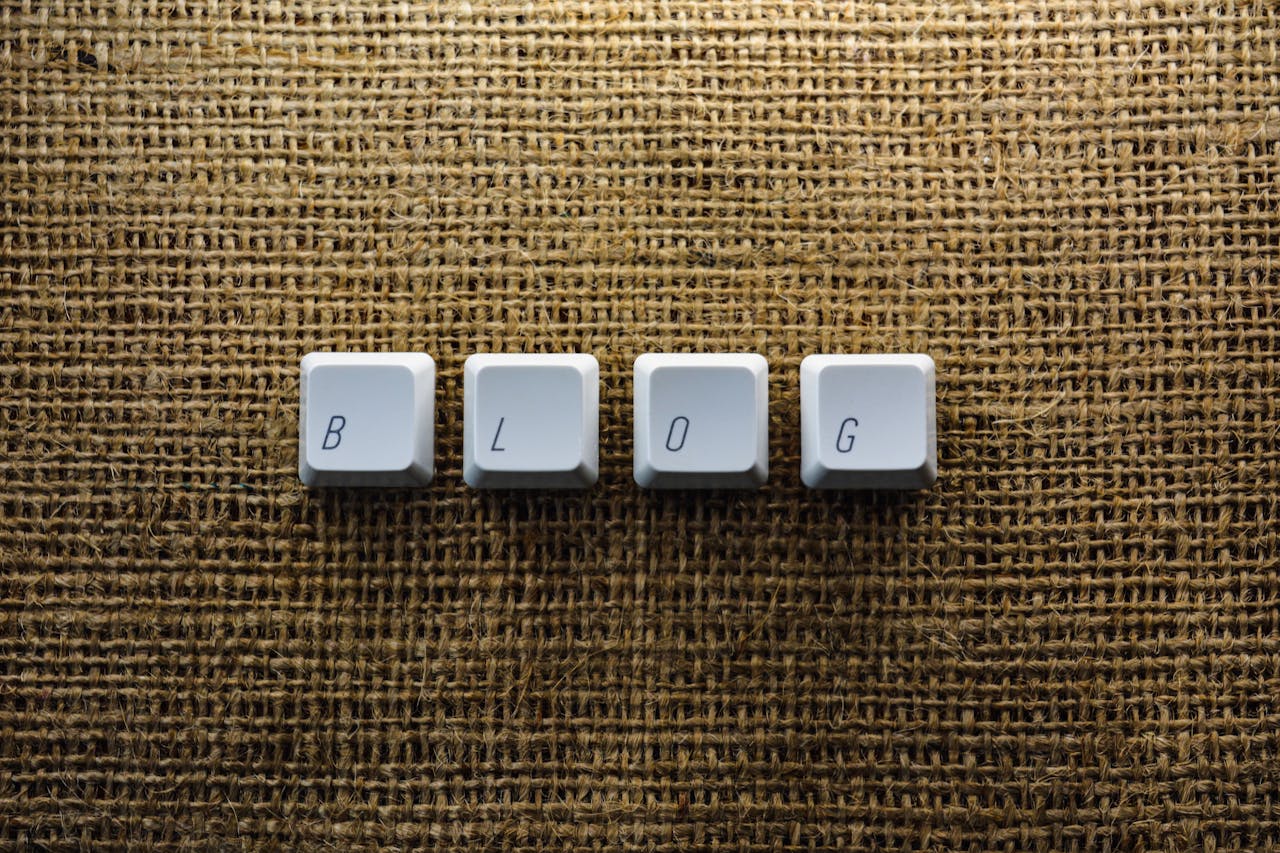 Close-up of keyboard keys spelling BLOG on a burlap surface, ideal for tech blogs.
